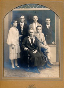 'This is a picture of my father's mother, sister and brothers after they were finally together again in America. My father was approx. 29 years old. Most families had a similar photo taken after arriving in America. This picture always brings back memories of this wonderful group of people. Pictured, from back to front, left to right: Mary Kathleen Sheehan, Cornelius Sheehan, Jerimah Sheehan, my father John Sheehan, my grandmother Nora Sheehan and William Sheehan.' 1926. Contributor: Claire McWade.