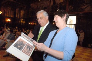 Mayor Menino views Road Show photographs from Dorchester with University Archivist Joanne Riley.