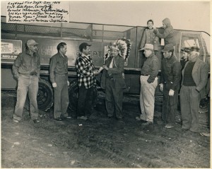 'This is a photo of the original Gayhead Fire Department in 1959. My father is second from the left. In 1978, I became the first female on the island to become a volunteer fireman. My father gave me his badge, number 16. In 1988 I became the first woman assistant fire chief on the island. The man in the headdress is Napoleon Madison, medicine man of the Wampanoag tribe in Gayhead. His son, Luther Madison, 3rd from the right, eventually became the next medicine man. Donald Malonson, 3rd from the left, was the fire chief. Pictured, from back to front, left to right: Horation Malonson, Jeff Madison, Bill Ryan, Larry Spitz, Donald Malonson, Napoleon Madison, Joe Horiagon, Luther Madison, Grover Ryan, Jesse Smalley. Location: Gayhead.' Contributor: Barbara Bassett. 