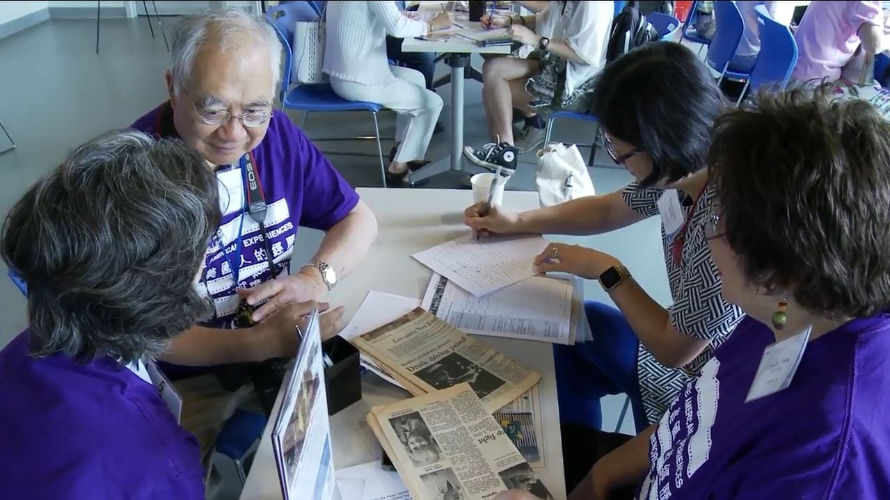 Attendees and volunteers wearing purple event t-shirts at the Chinese American Experiences Mass. Memories Road Show