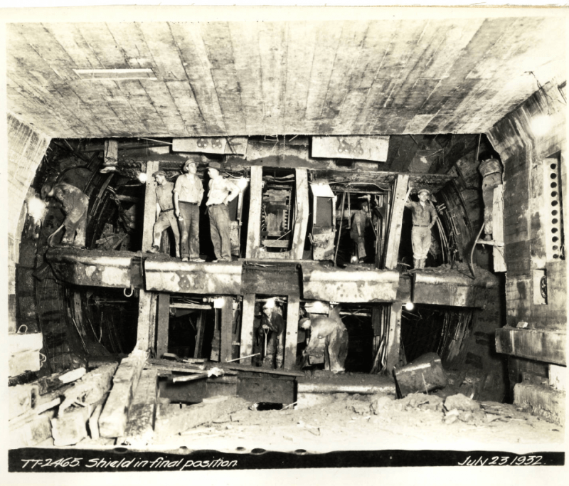 Black-and-white photo of workers standing inside Sumner Tunnel