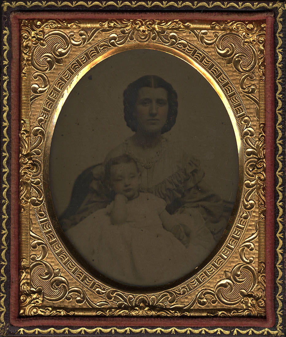 Daguerreotype portrait in gold case of woman holding a baby