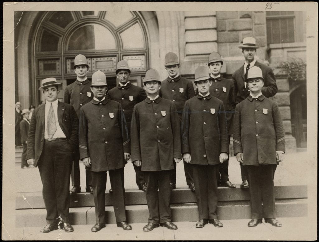Black and white photo of police officers in uniform.