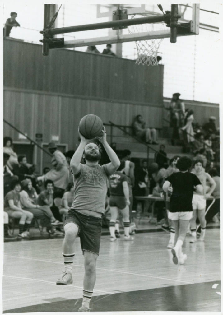 Paul Tenney shooting a layup at student-teacher game, 1976.