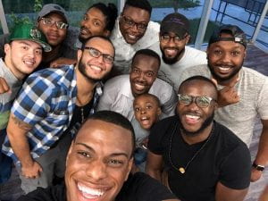 A group of young men pose for a selfie after an AMEND session.