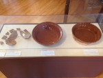 Excavated fragments of a milkpan, a reconstructed vessel, and a modern recreation based on these examples.