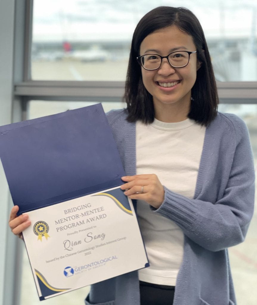 Faculty member Qian Song with her Bridging Mentor-Mentee Program Award from the Chinese Gerontology Studies Interest Group 
