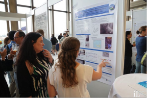 Amy explaining her results to her adviser - Dean Hannigan - at the poster session in Prague (Photo by Steven Nye)