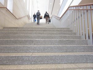 students walk upstairs in campus center