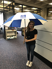 Student Rachel Hoffman with umbrella