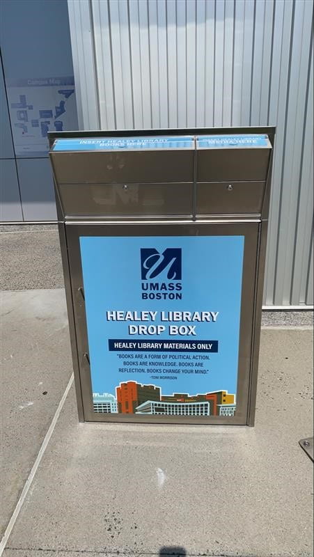 Picture of Healey Library's outdoor bookdrop featuring two slots for returning books and media