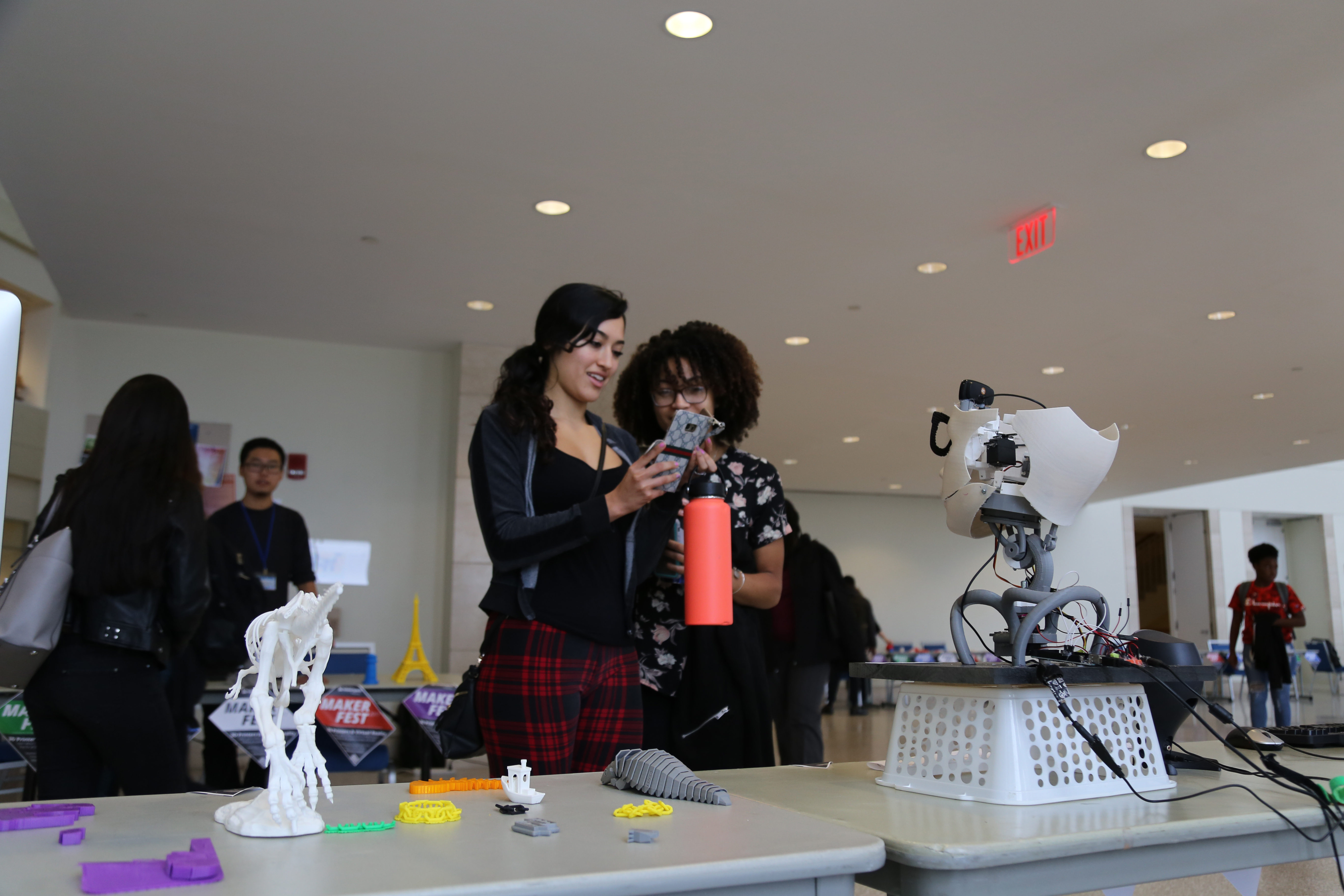 students looking at robot