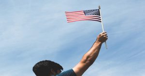 woman of color waving American flag