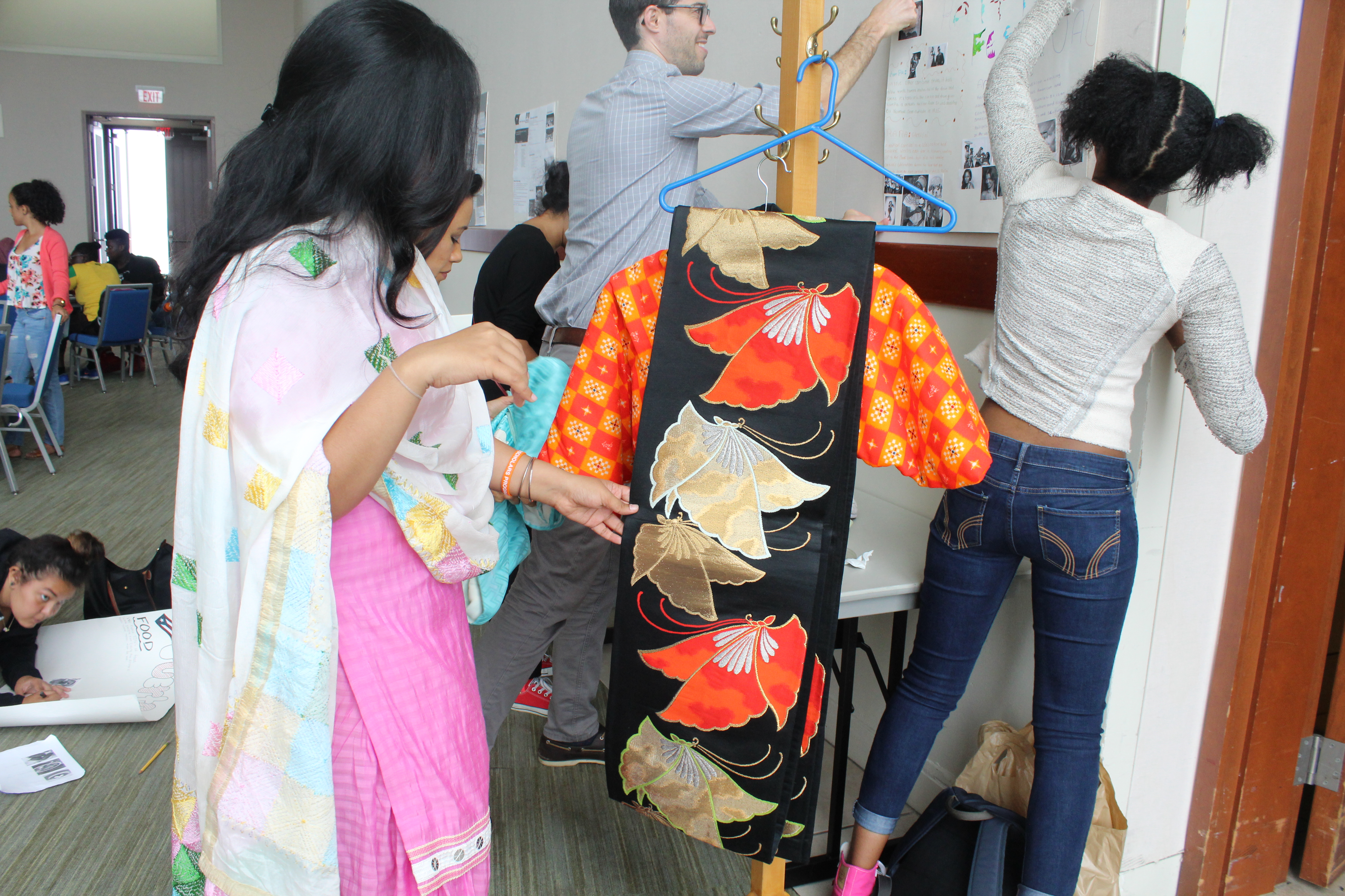 One of the staffs member looked at one of the clothes displayed of their tradition!