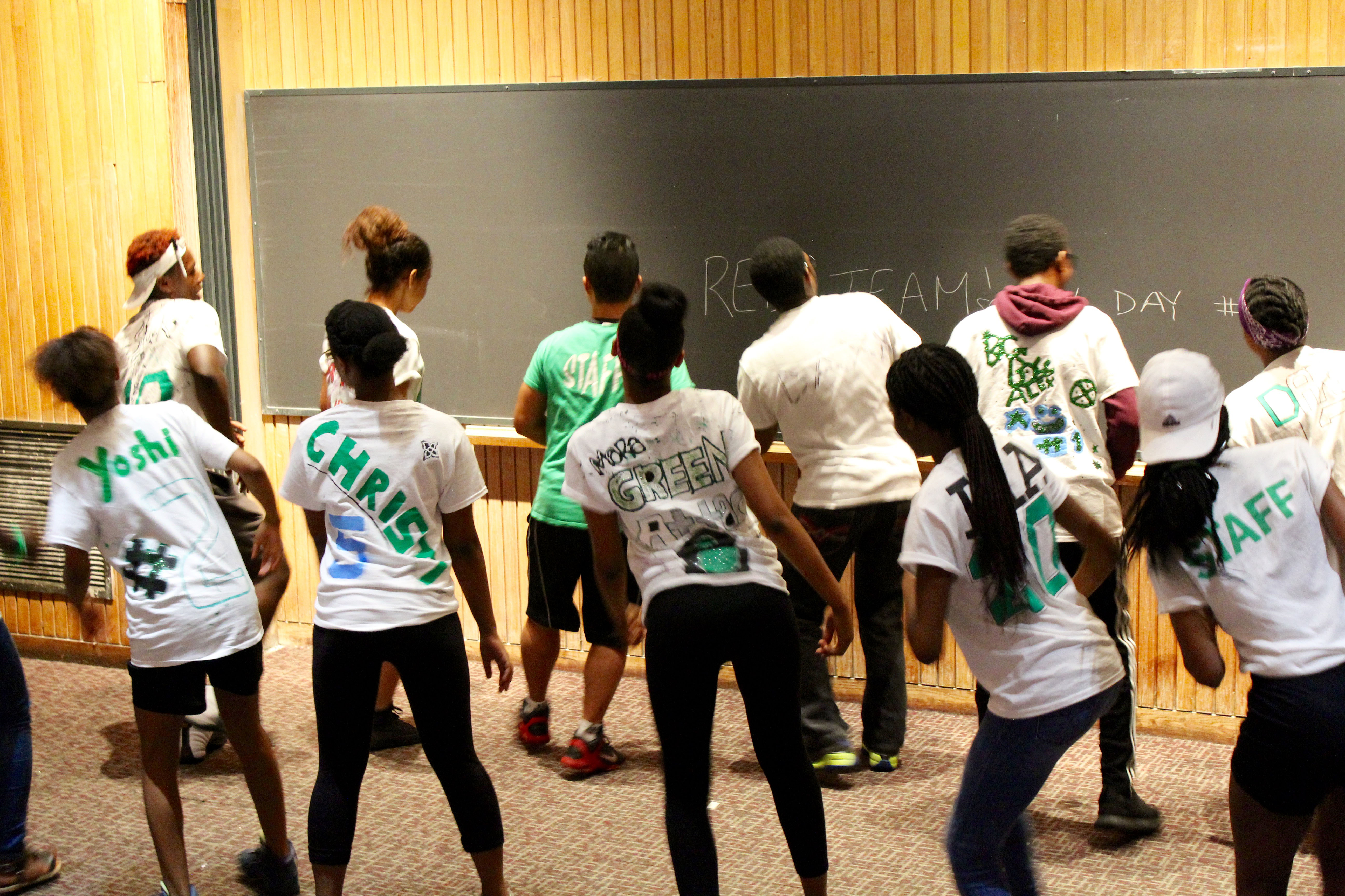Green Team make sure their dance flash their individual art design on the back of their shirt!