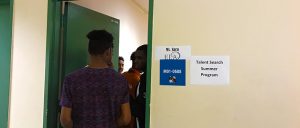 Back of students entering a classroom.