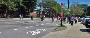 Students cross the street on and by the crosswalk.