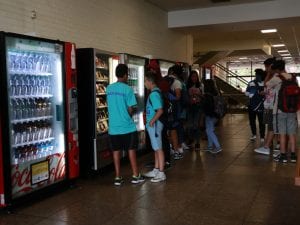students buying snacks from the vending machine