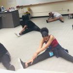 students are stretching before dance class