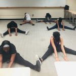 students are stretching before dance class