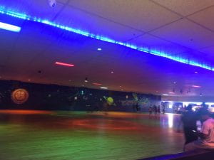 Image of the roller rink with neon lights.